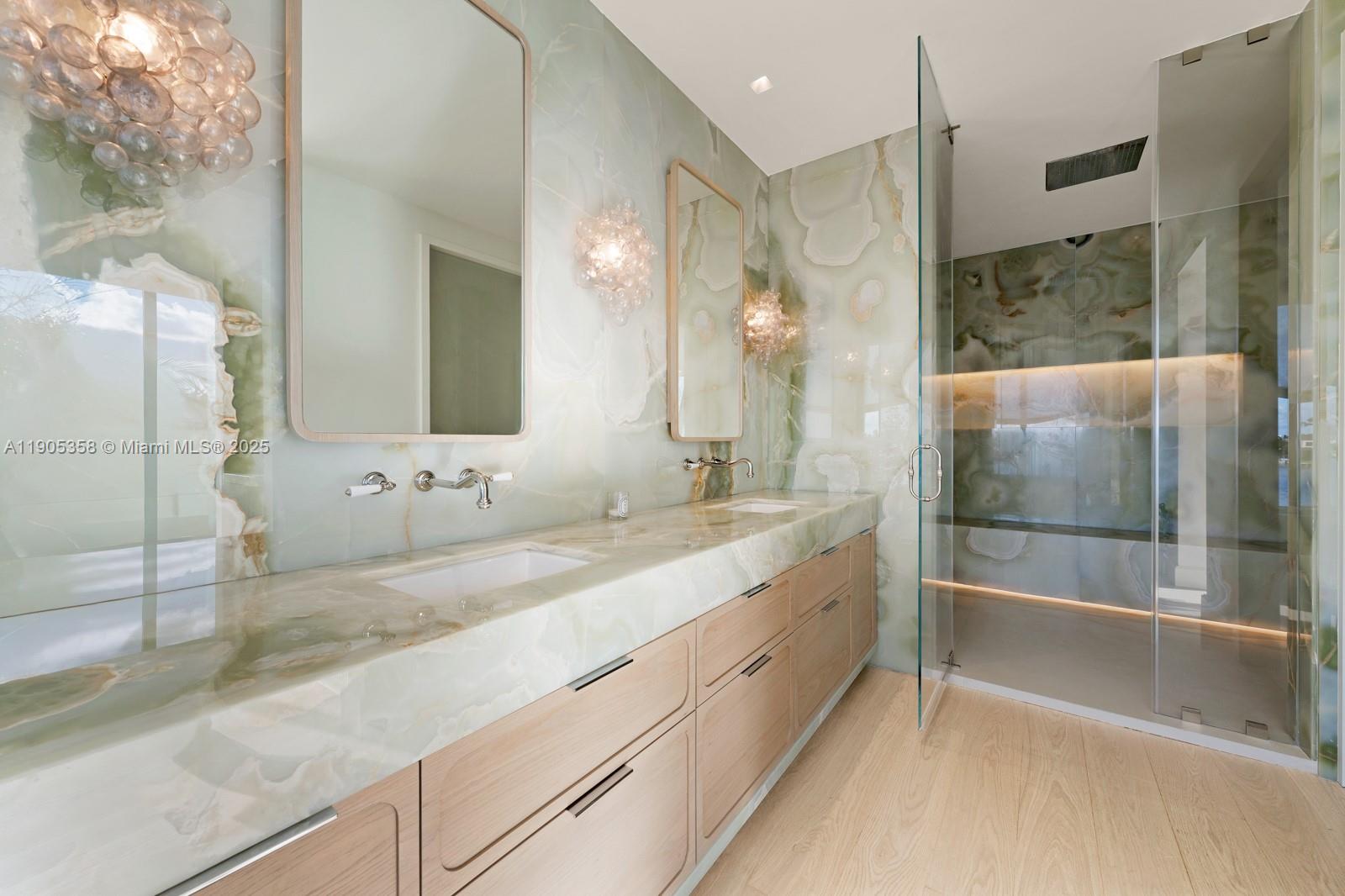 1165 North Biscayne Point Road Miami Beach, FL 33141 - Photo 15 of 31 a bathroom with a double vanity sink and mirror