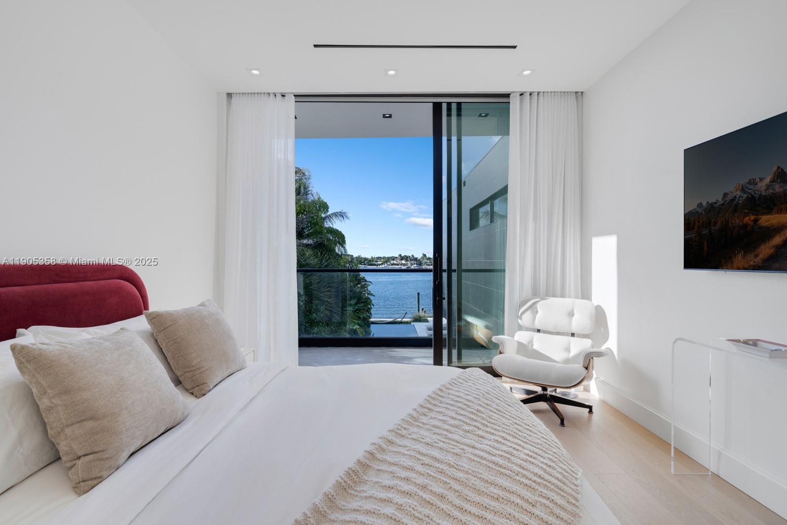 1165 North Biscayne Point Road Miami Beach, FL 33141 - Photo 18 of 31 a bedroom with a bed and a flat screen tv