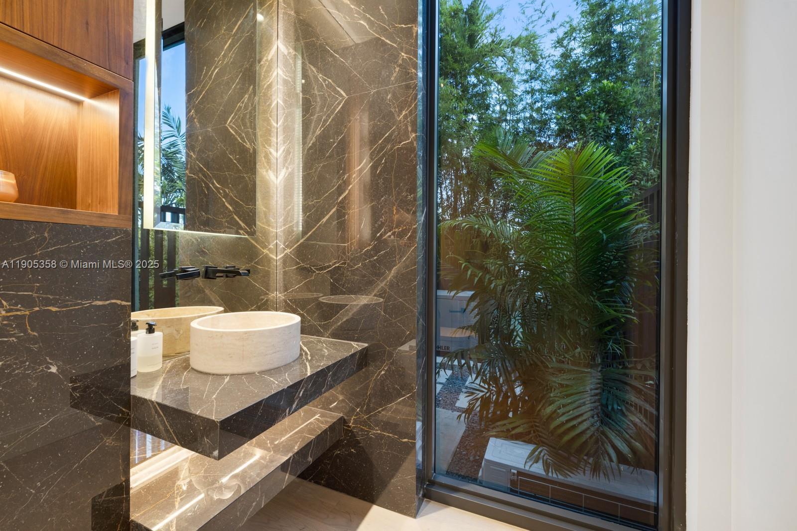 1165 North Biscayne Point Road Miami Beach, FL 33141 - Photo 24 of 31 a bathroom with a mirror