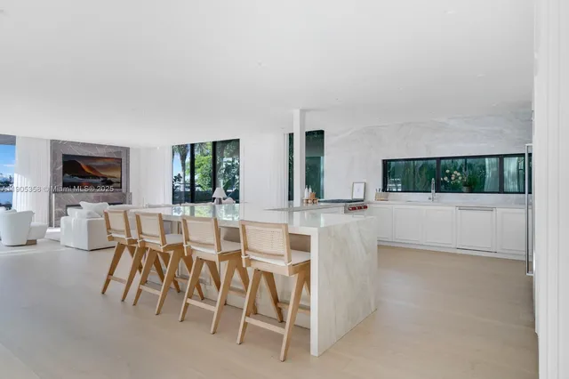 a view of a dining room with furniture and a flat screen tv