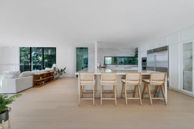 a dining room with furniture and a large window