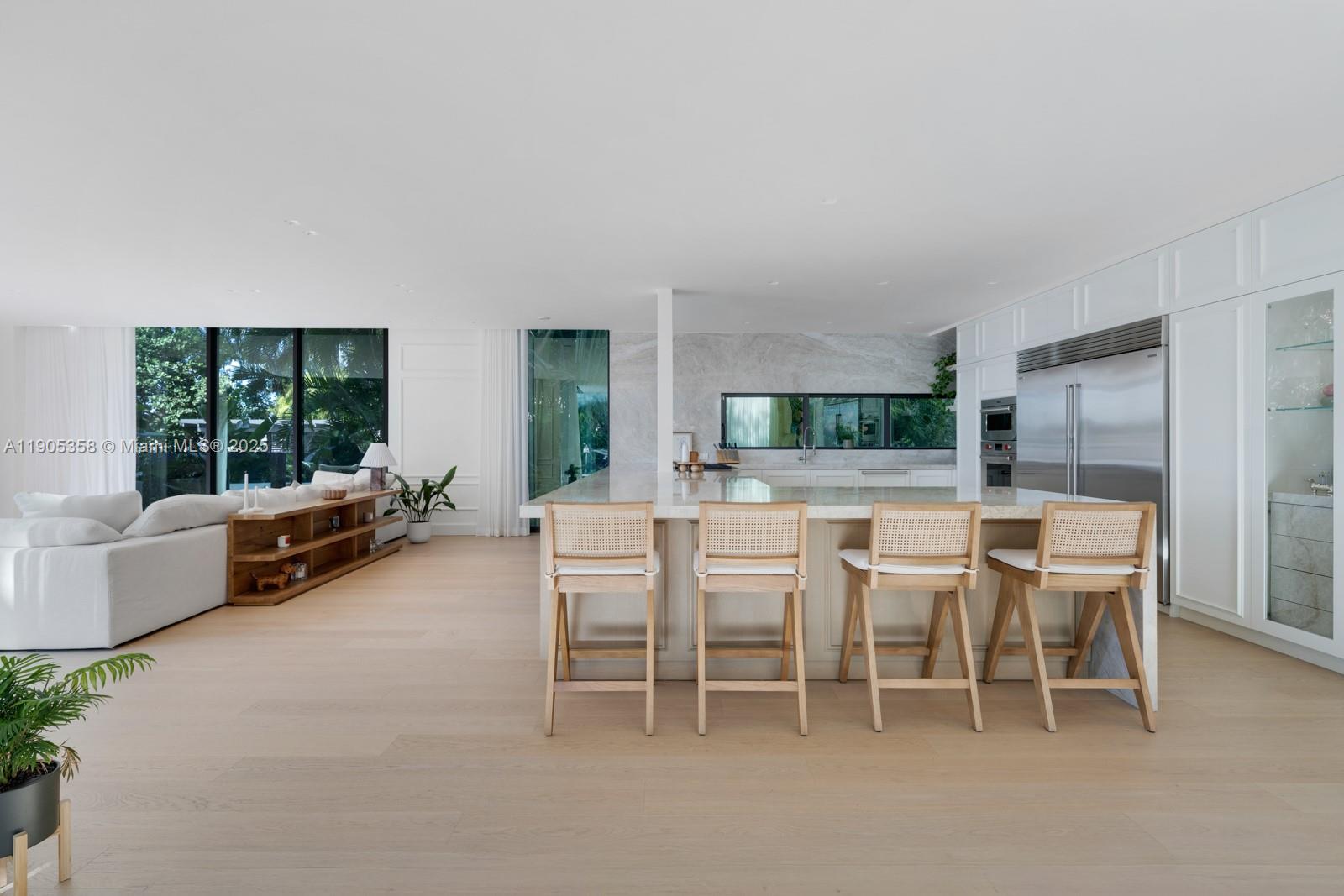 1165 North Biscayne Point Road Miami Beach, FL 33141 - Photo 8 of 31 a dining room with furniture and a large window