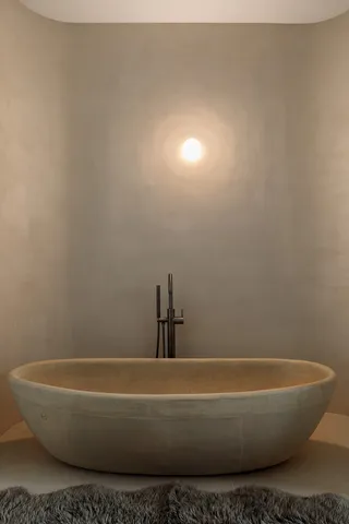 a white bath tub sitting next to a white toilet