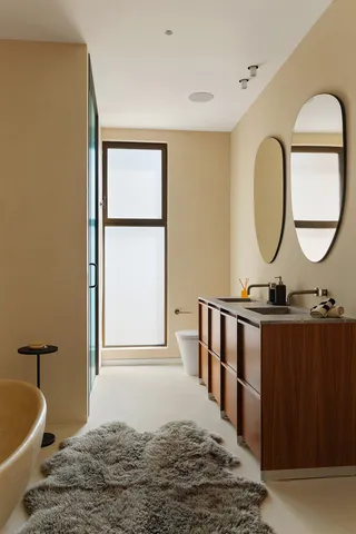 a bed room with a bed mirror and a window