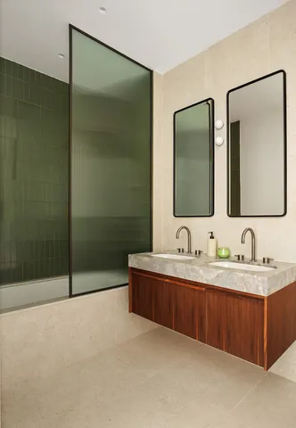 a bathroom with double sink and mirror