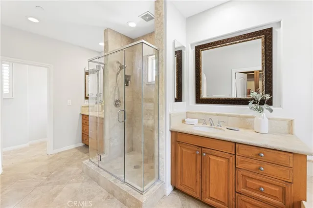 a bathroom with a sink a toilet a mirror and shower