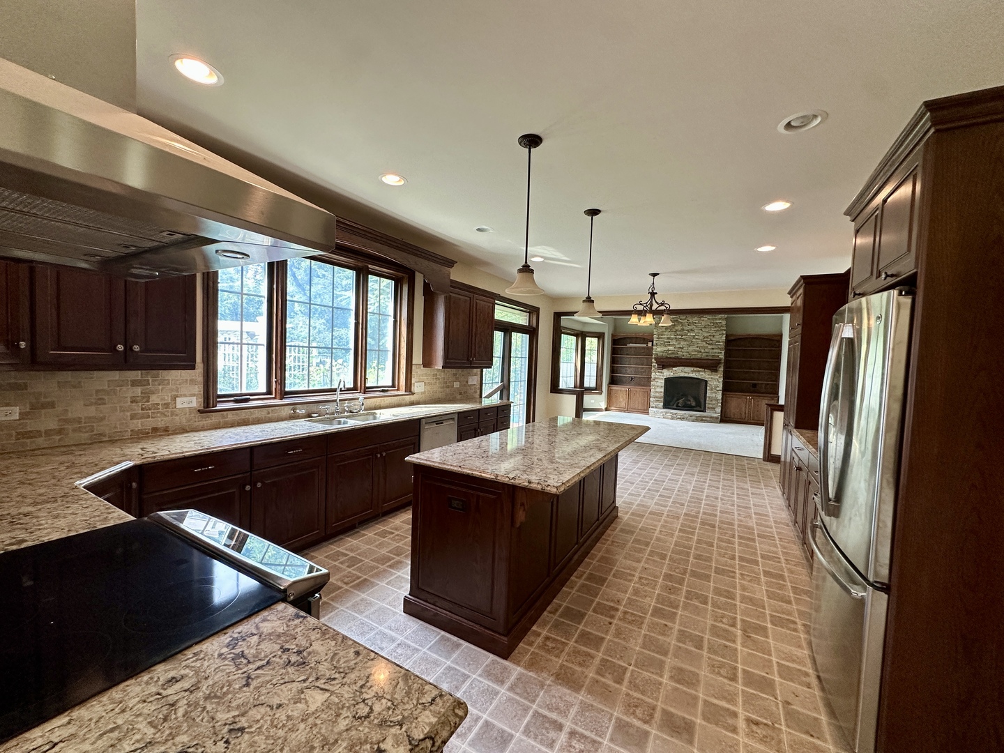 8207 West 30th Street North Riverside, IL 60546 - Photo 3 of 39 a kitchen with stainless steel appliances granite countertop a refrigerator a sink dishwasher a stove and a dining table with wooden floor