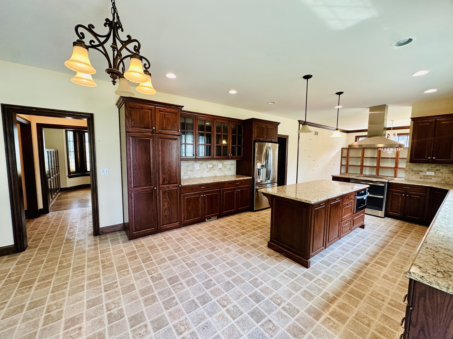 8207 West 30th Street North Riverside, IL 60546 - Photo 5 of 39 a kitchen with stainless steel appliances wooden cabinets a stove top oven and a refrigerator