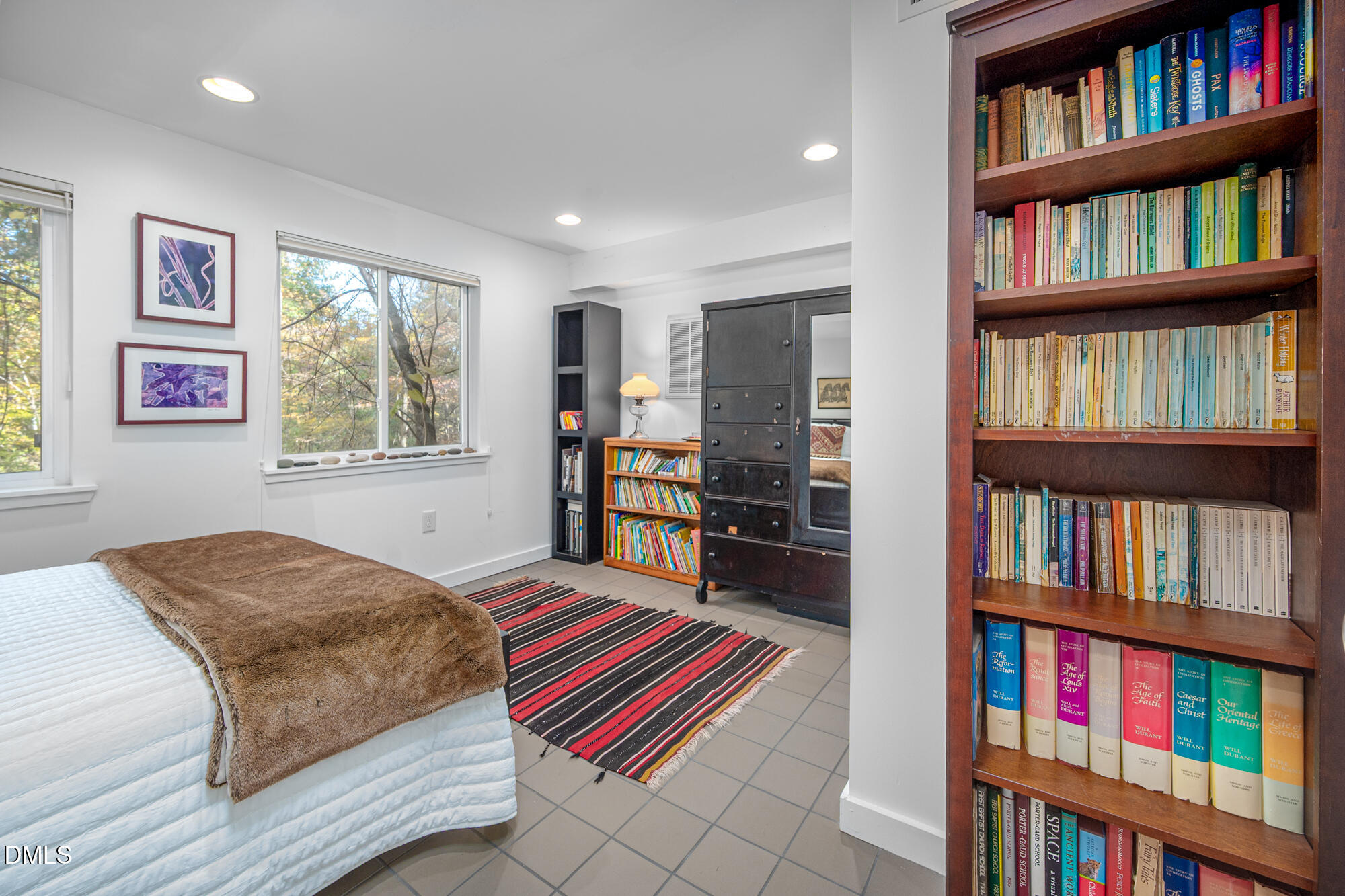 1030 Highland Woods Road Chapel Hill, NC 27517 - Photo 46 of 64 a bedroom with a bed and a book shelf