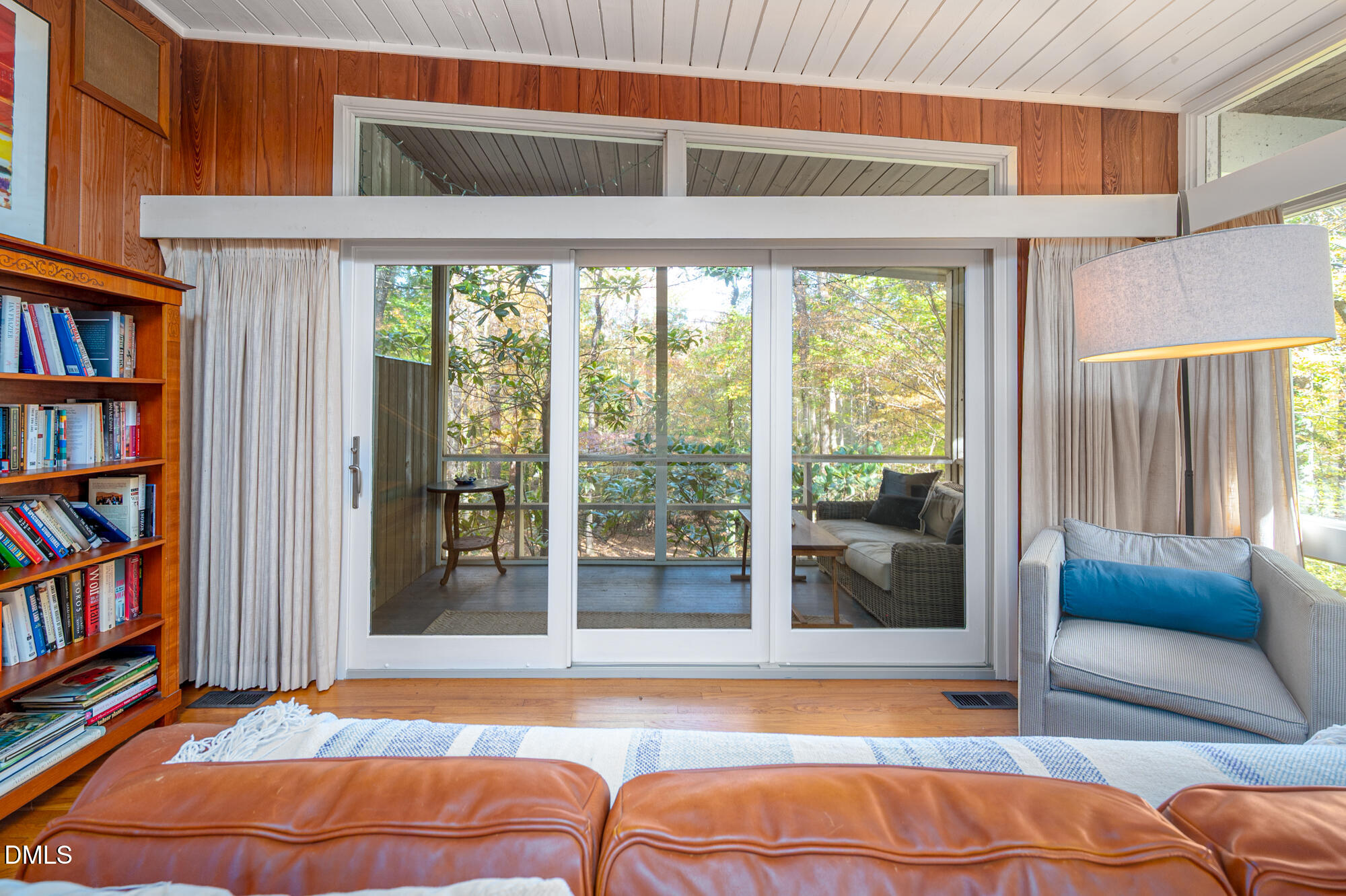 1030 Highland Woods Road Chapel Hill, NC 27517 - Photo 8 of 64 a living room with a large window and a book shelf
