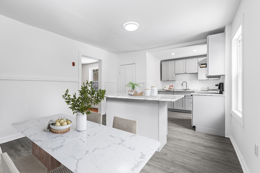 597 Mendon Road Northbridge, MA 01534 - Photo 4 of 13 a kitchen with kitchen island white cabinets and refrigerator