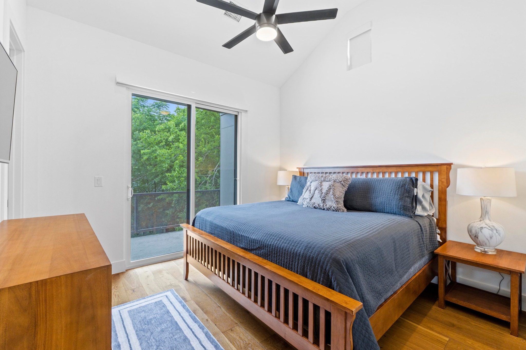 1706 Perez Street, Unit 2 Austin, TX 78721 - Photo 18 of 29 A tranquil bedroom retreat features a private balcony overlooking verdant natural scenery.