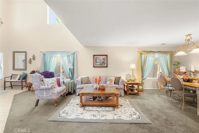 a dining room with furniture and large windows