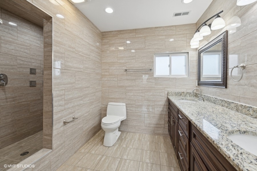 369 Blackhawk Road Riverside, IL 60546 - Photo 12 of 31 a bathroom with a granite countertop sink a toilet and a shower