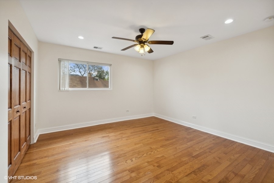 369 Blackhawk Road Riverside, IL 60546 - Photo 16 of 31 wooden floor in an empty room with a window