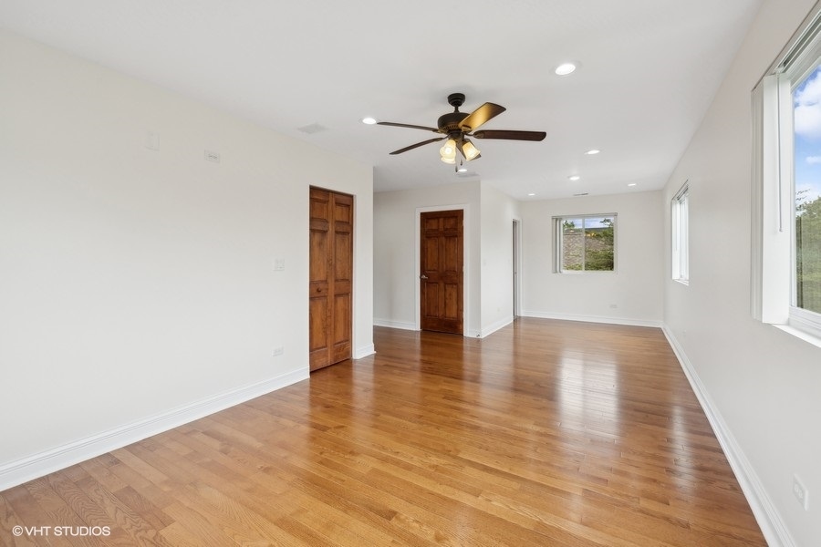 369 Blackhawk Road Riverside, IL 60546 - Photo 20 of 31 a view of an empty room with window and wooden floor