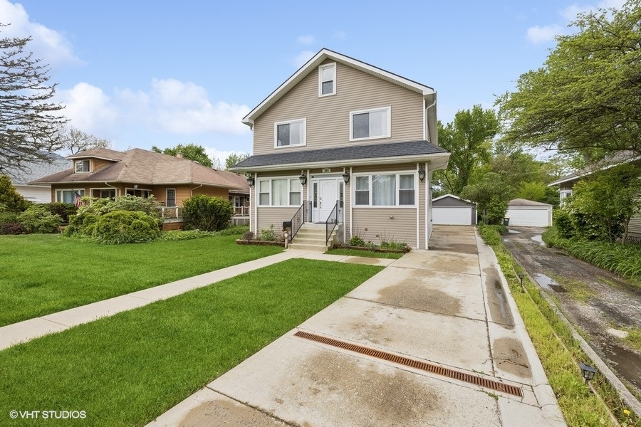 369 Blackhawk Road Riverside, IL 60546 - Photo 3 of 31 a front view of a house with a yard