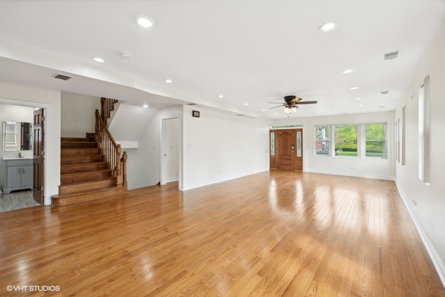 369 Blackhawk Road Riverside, IL 60546 - Photo 5 of 31 a view of an empty room with wooden floor and a window