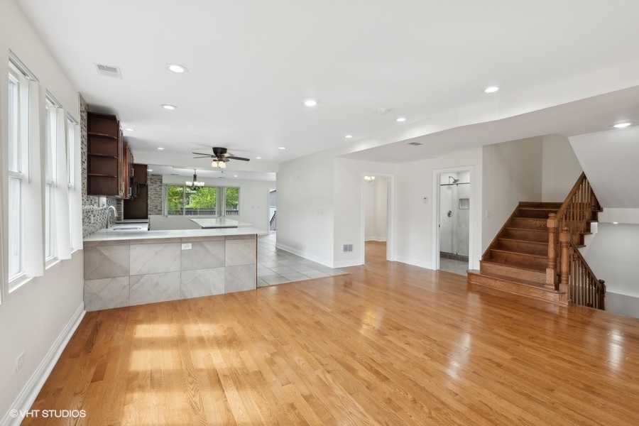 369 Blackhawk Road Riverside, IL 60546 - Photo 6 of 31 a large kitchen with stainless steel appliances kitchen island a large counter top and a wooden floors