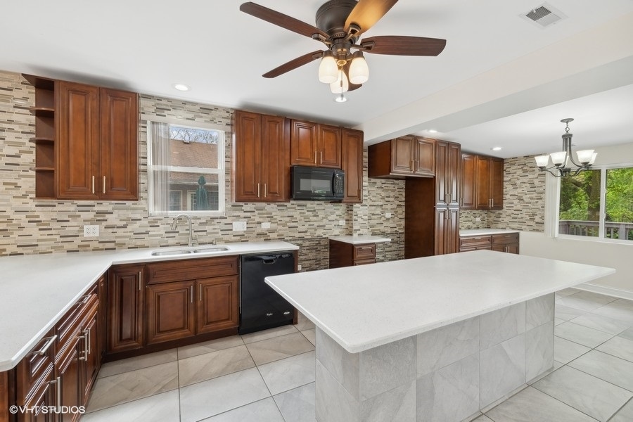 369 Blackhawk Road Riverside, IL 60546 - Photo 7 of 31 a kitchen with a stove a sink and a refrigerator