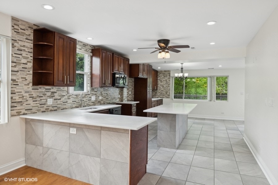 369 Blackhawk Road Riverside, IL 60546 - Photo 8 of 31 a kitchen with a sink a counter top space appliances and cabinets