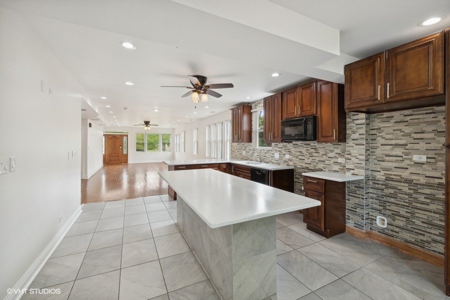 369 Blackhawk Road Riverside, IL 60546 - Photo 9 of 31 a large kitchen with stainless steel appliances granite countertop a sink and cabinets