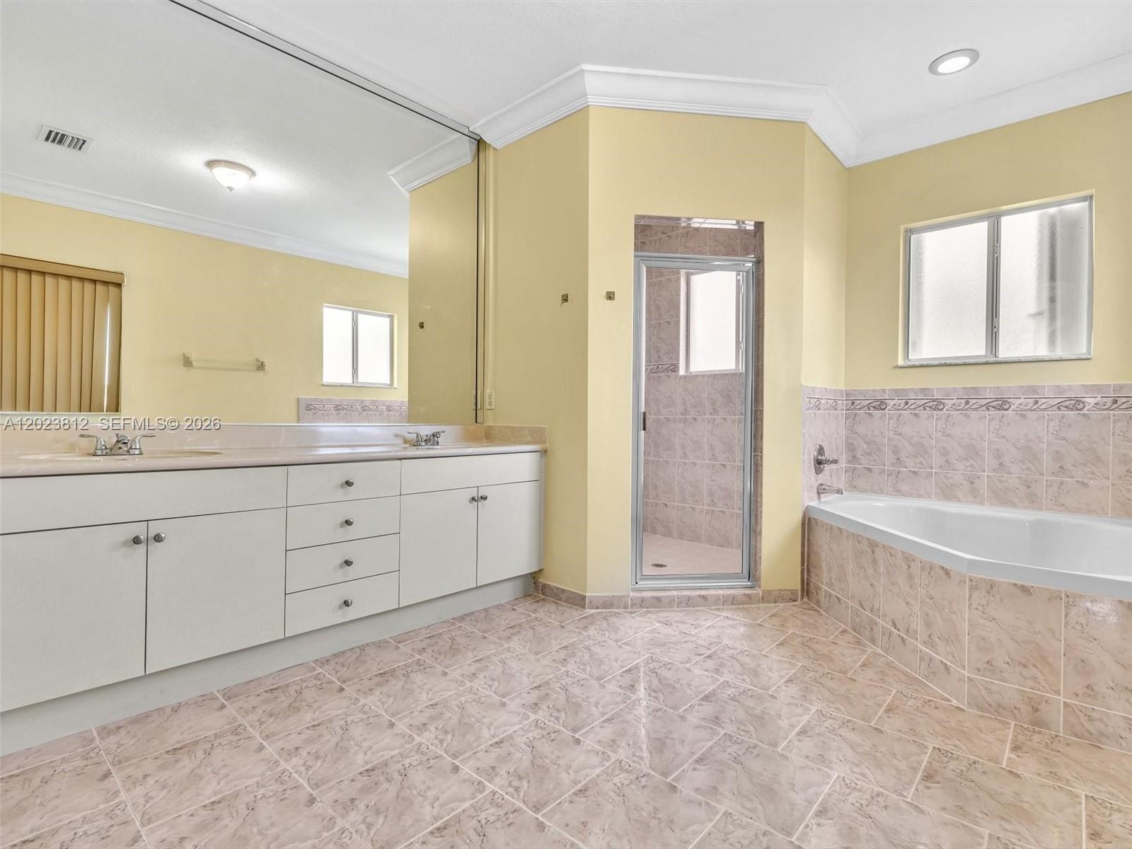 2864 Southwest 138th Path Miami, FL 33175 - Photo 23 of 40 a spacious bathroom with a granite countertop sink a mirror a bathtub and