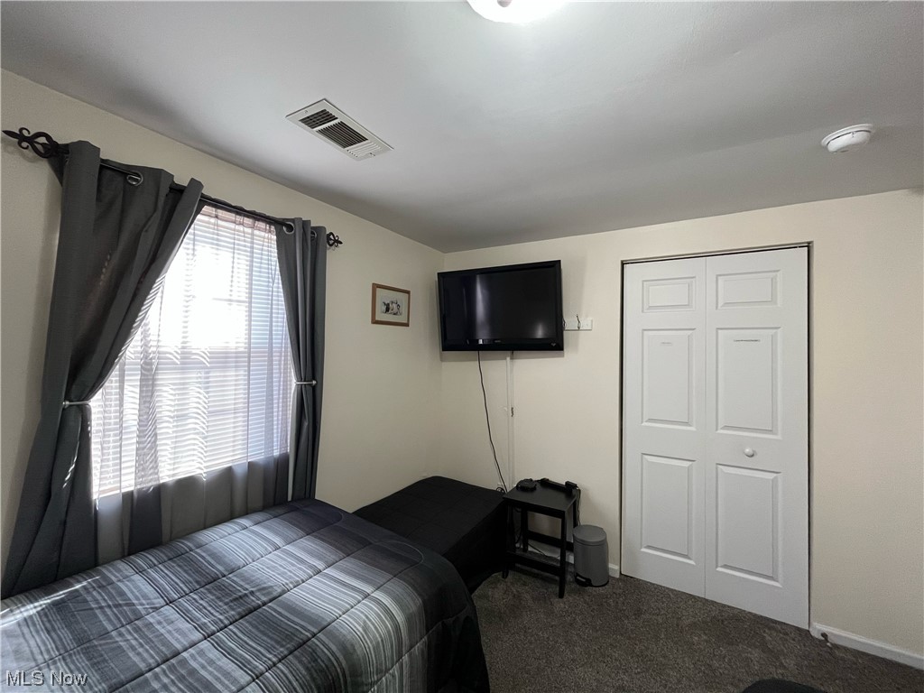 4972 West Fremont Road Port Clinton, OH 43452 - Photo 16 of 29 Bedroom with dark carpet and a closet