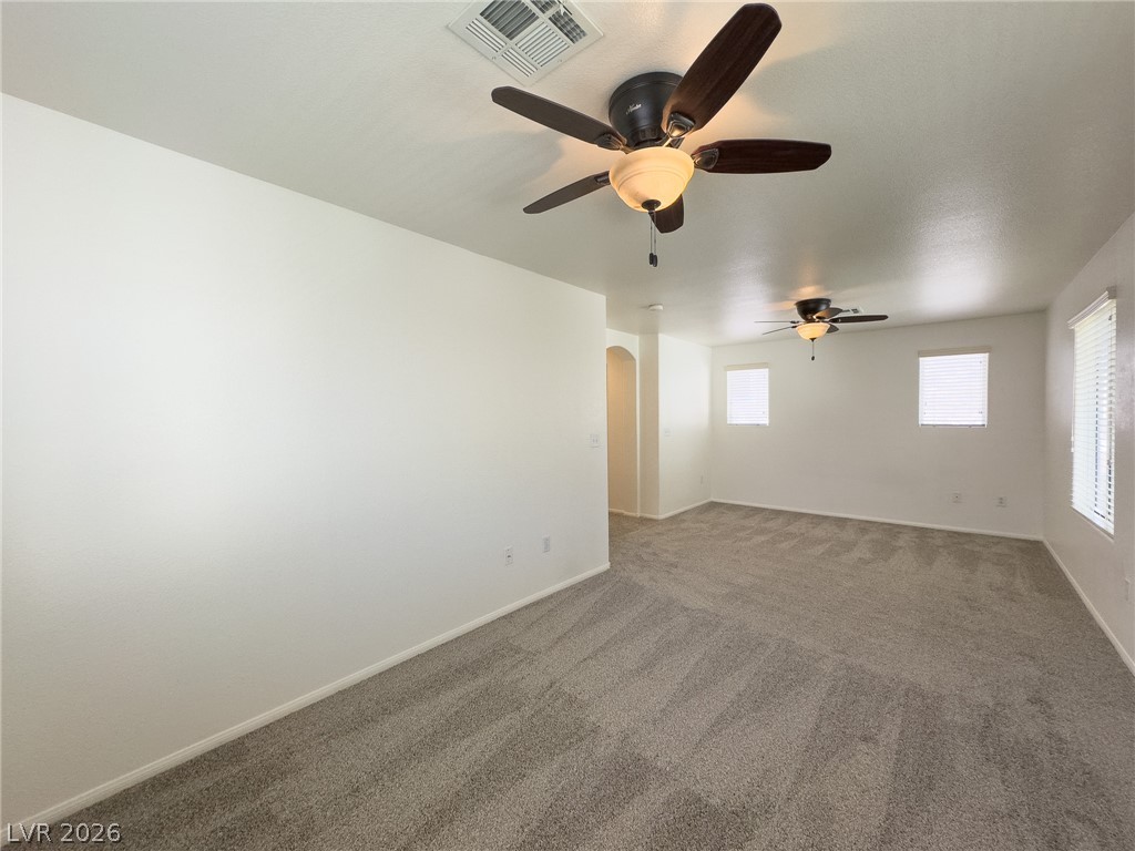 9456 Grandview Spring Avenue Las Vegas, NV 89166 - Photo 24 of 49 A spacious room offers ample natural light and comfortable carpeting throughout.