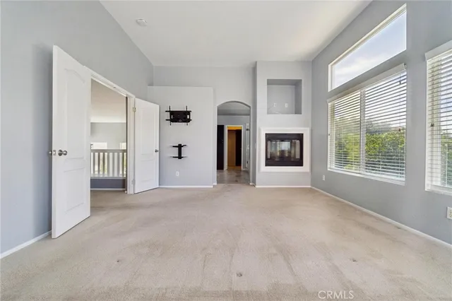 an empty room with windows and mountain view