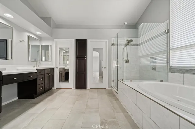 a spacious bathroom with a bathtub and a shower