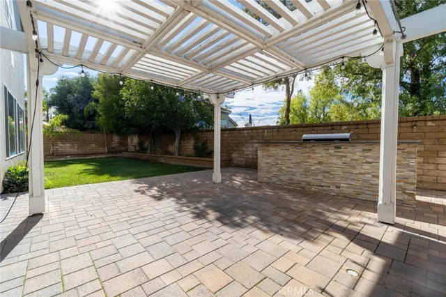 a view of a yard with plants and large trees
