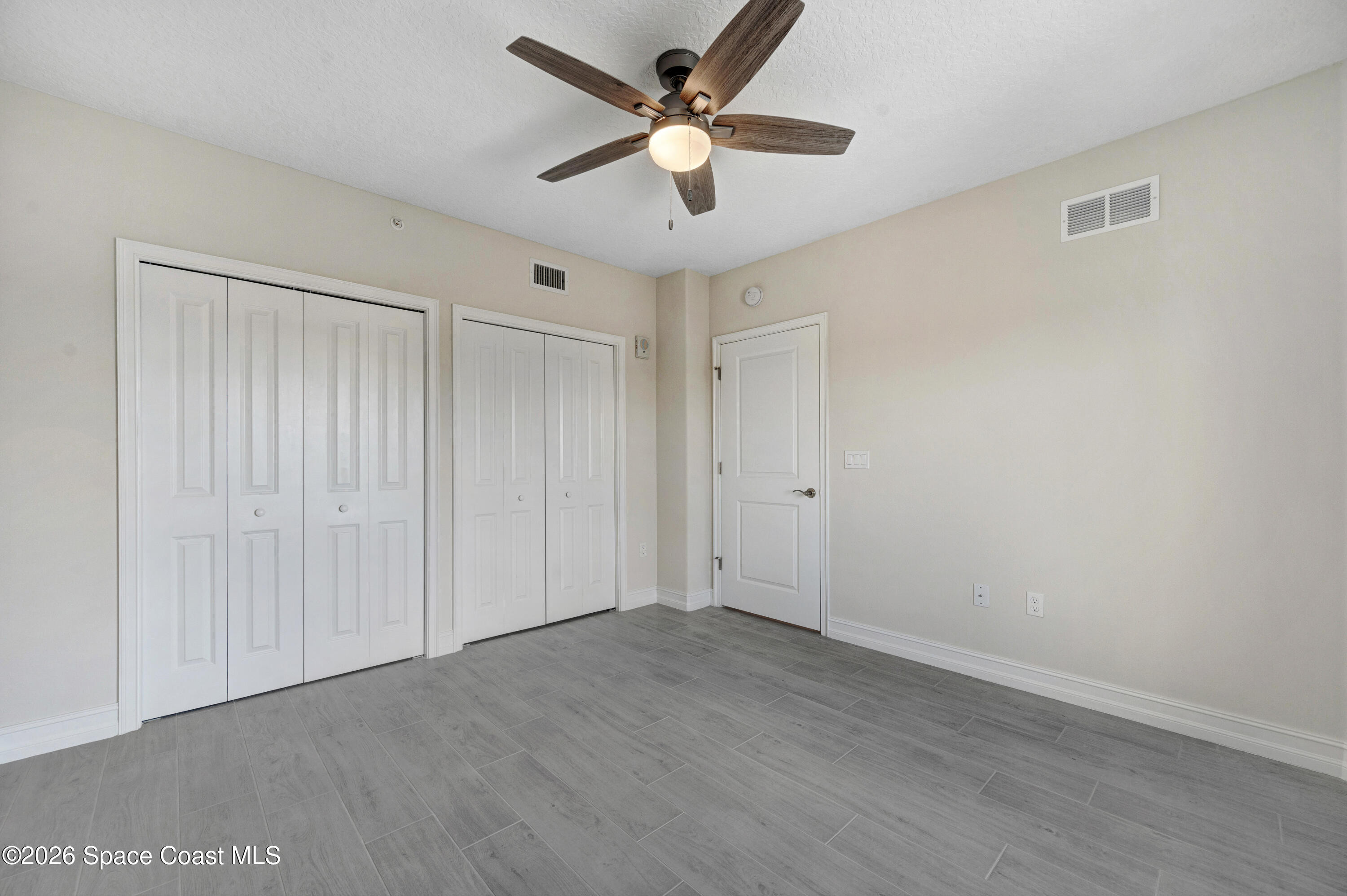 1805 Riverside Drive, Unit 304 Titusville, FL 32780 - Photo 21 of 46 wooden floor in an empty room