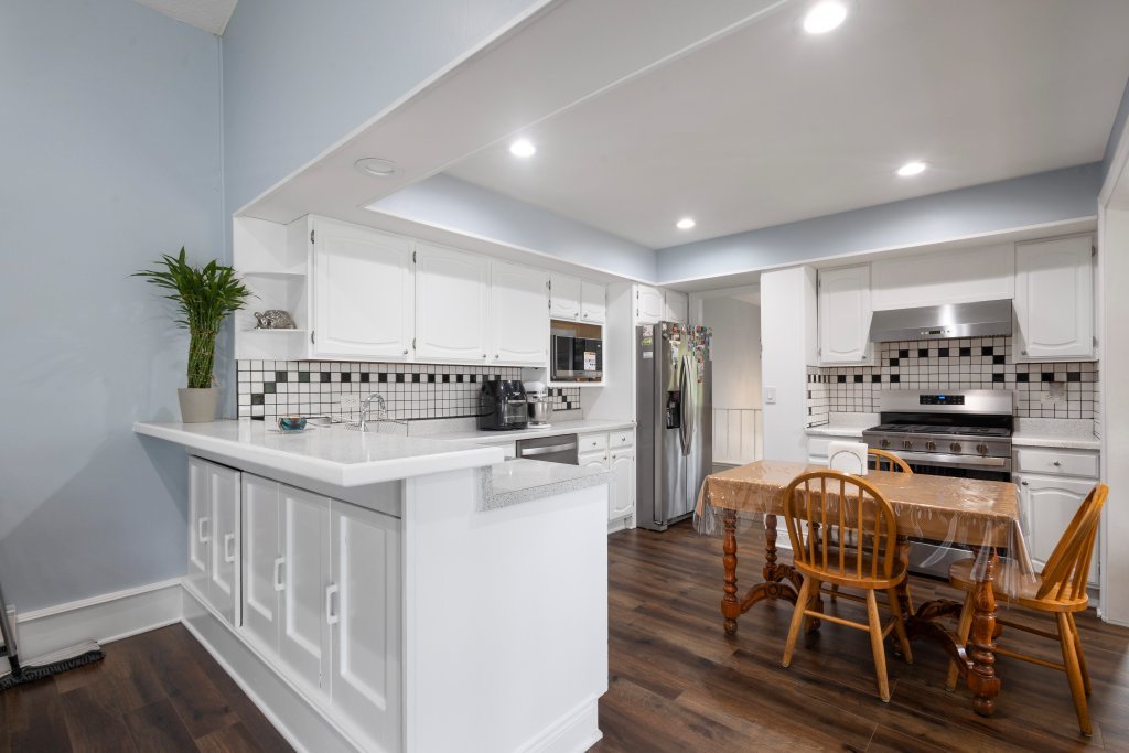 2004 East Parkview Circle Hoffman Estates, IL 60169 - Photo 11 of 36 a kitchen with stainless steel appliances kitchen island granite countertop a refrigerator a stove a sink dishwasher and white cabinets with wooden floor