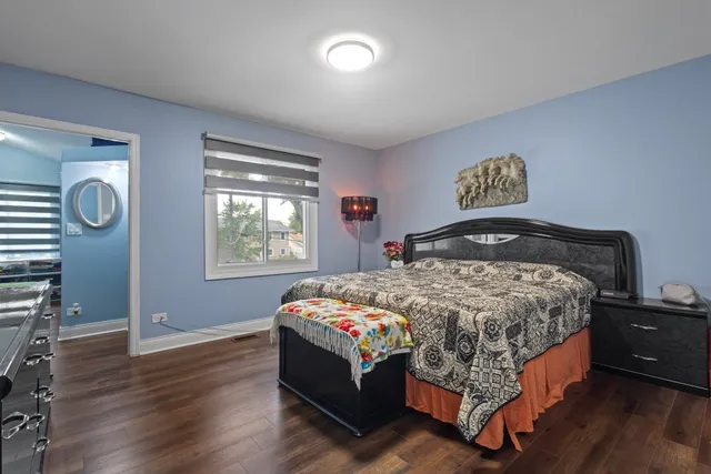 a bedroom with a bed and window