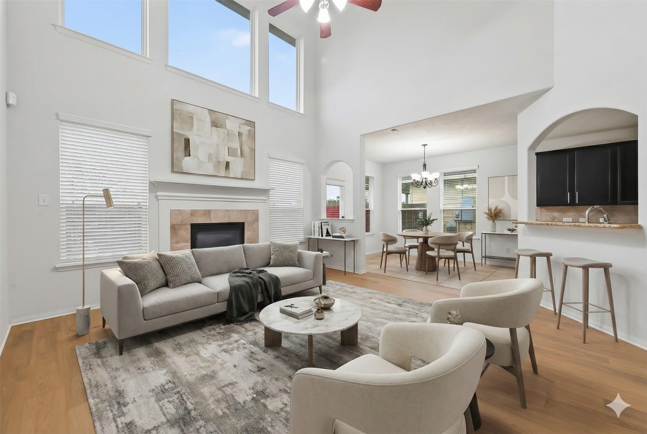 a living room with furniture a flat screen tv and kitchen view