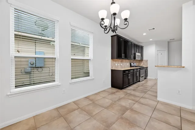 a kitchen with stainless steel appliances granite countertop a sink a stove and a refrigerator