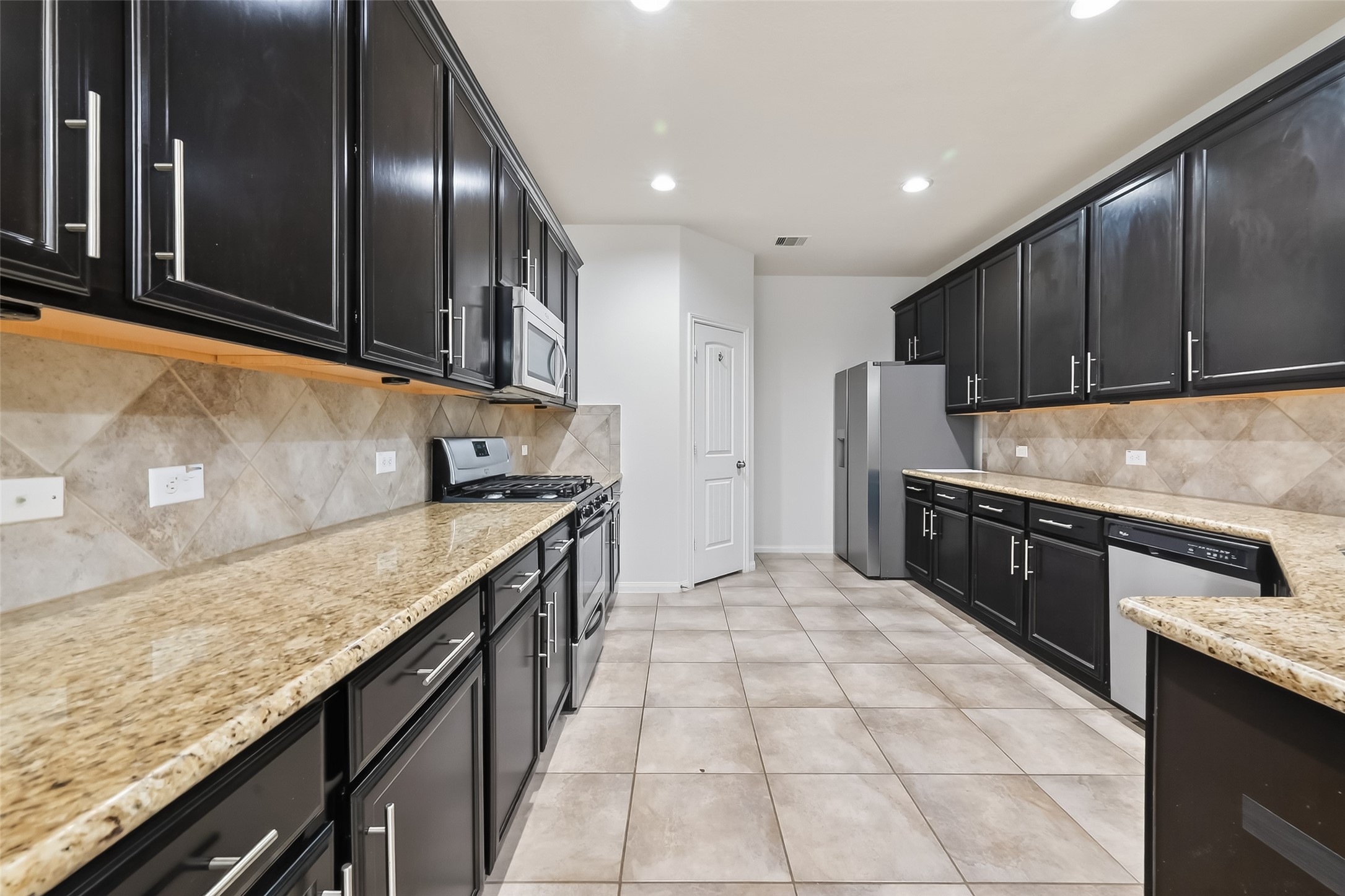 25018 Clover Ranch Drive Katy, TX 77494 - Photo 14 of 45 a kitchen with stainless steel appliances granite countertop a sink a stove and a refrigerator