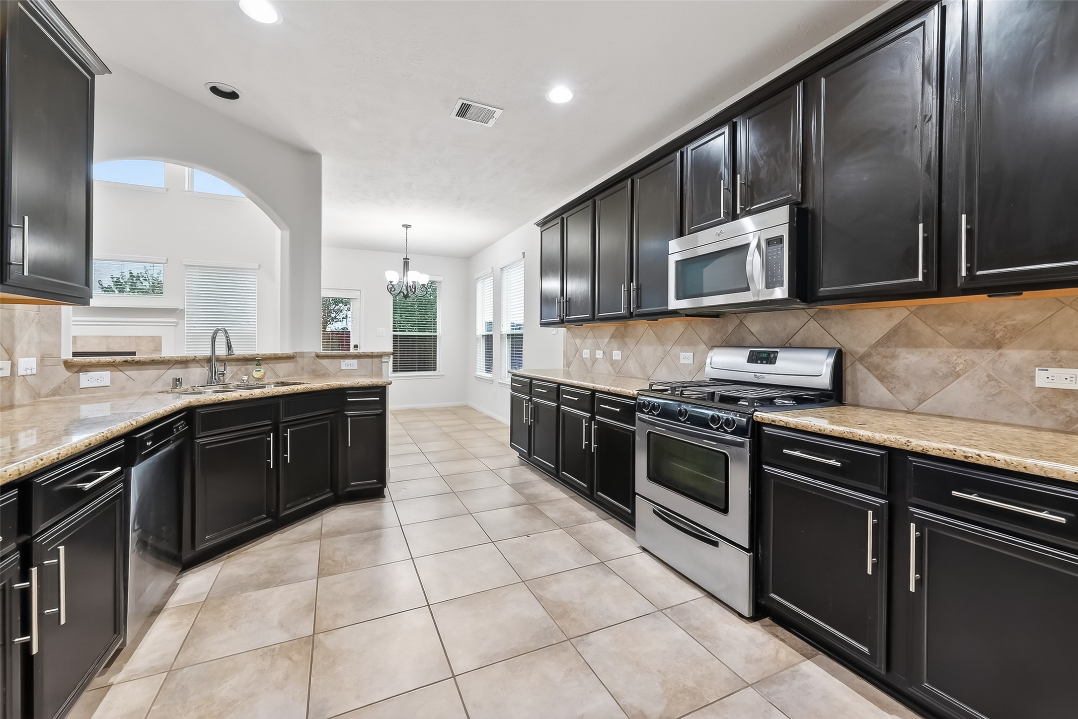 25018 Clover Ranch Drive Katy, TX 77494 - Photo 17 of 45 a large kitchen with stainless steel appliances and a stove top oven