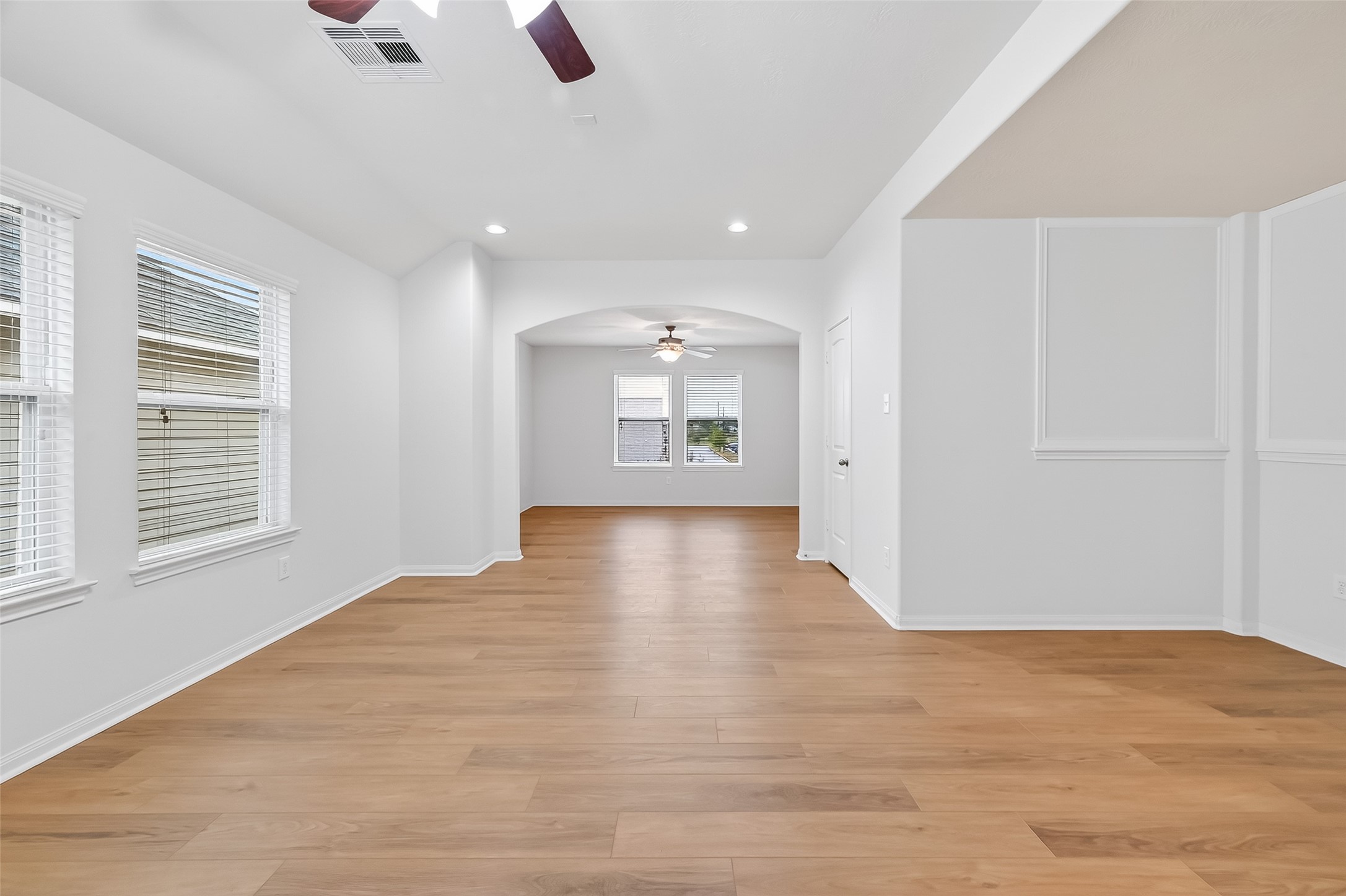 25018 Clover Ranch Drive Katy, TX 77494 - Photo 25 of 45 a view of an empty room with chandelier and wooden floor