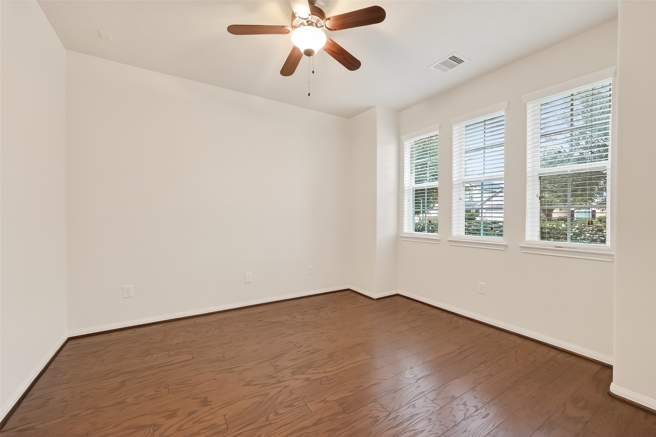 25018 Clover Ranch Drive Katy, TX 77494 - Photo 27 of 45 a view of an empty room with wooden floor and a window
