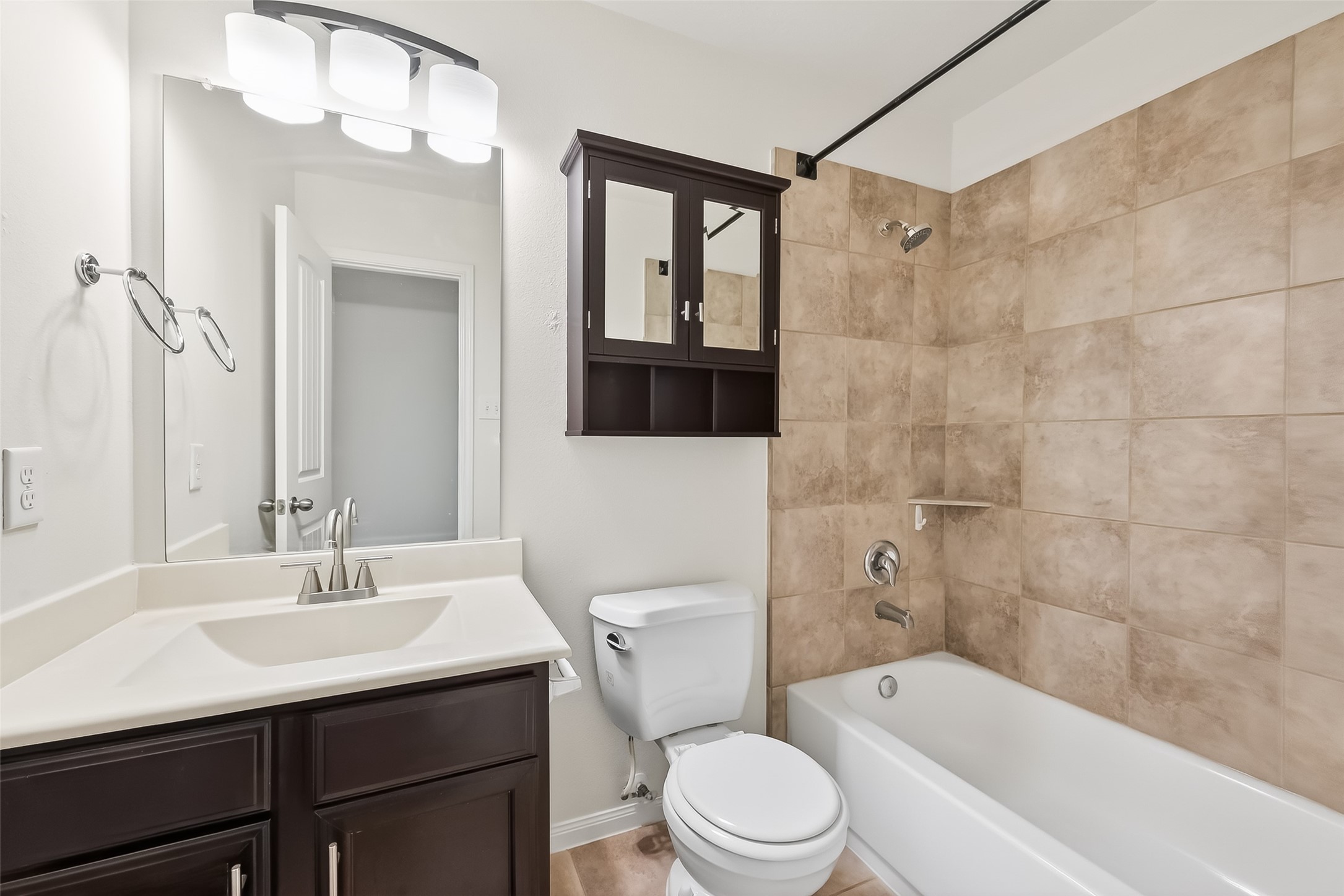 25018 Clover Ranch Drive Katy, TX 77494 - Photo 28 of 45 a bathroom with a sink a toilet a mirror a vanity and bathtub
