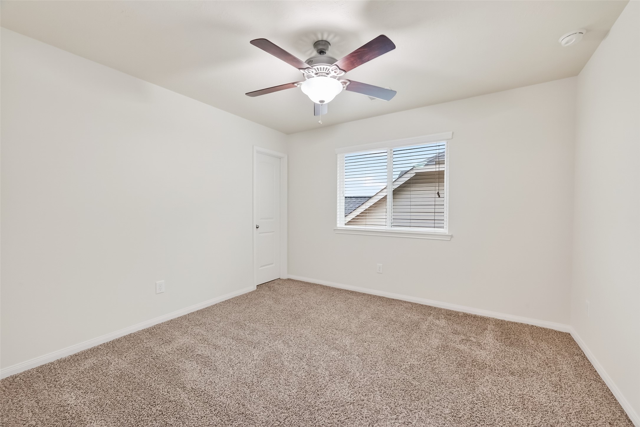 25018 Clover Ranch Drive Katy, TX 77494 - Photo 29 of 45 an empty room with window and ceiling fan