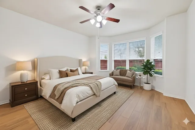 a bedroom with a bed and a large window