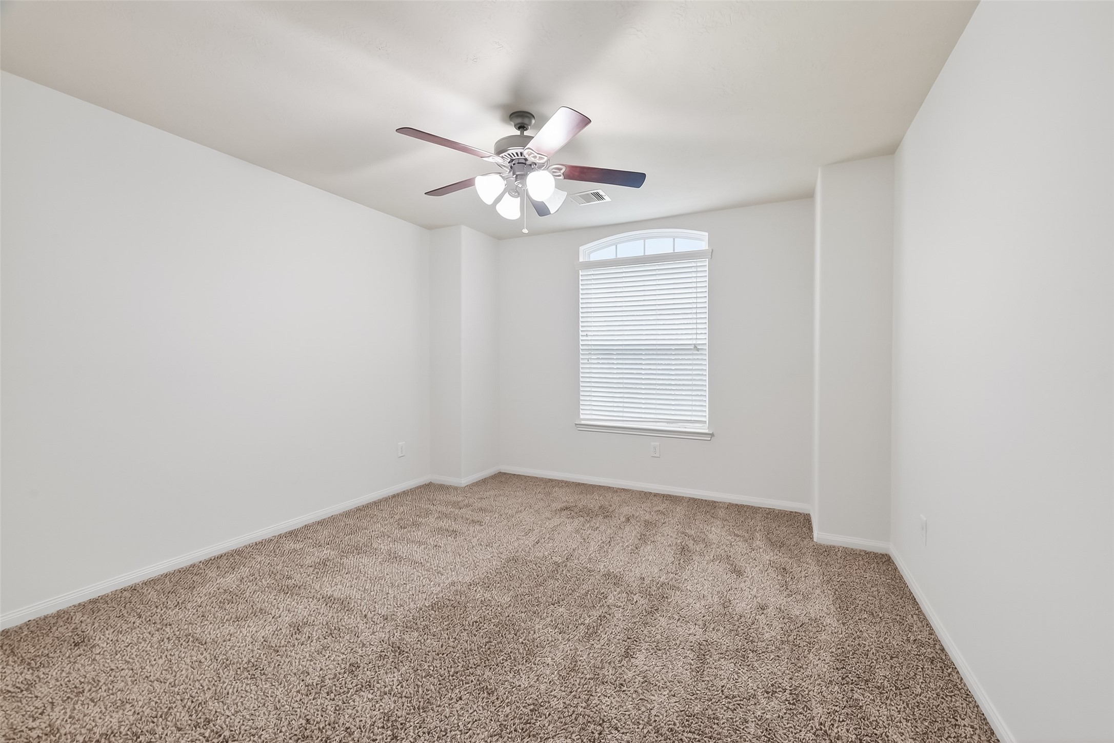 25018 Clover Ranch Drive Katy, TX 77494 - Photo 34 of 45 an empty room with windows and fan