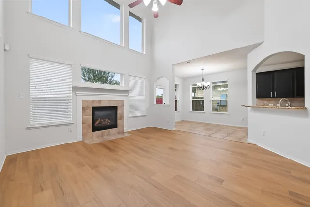 a view of a livingroom with wooden floor and staircase