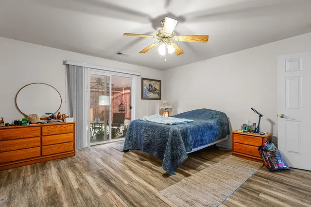 a bedroom with a bed and a chandelier