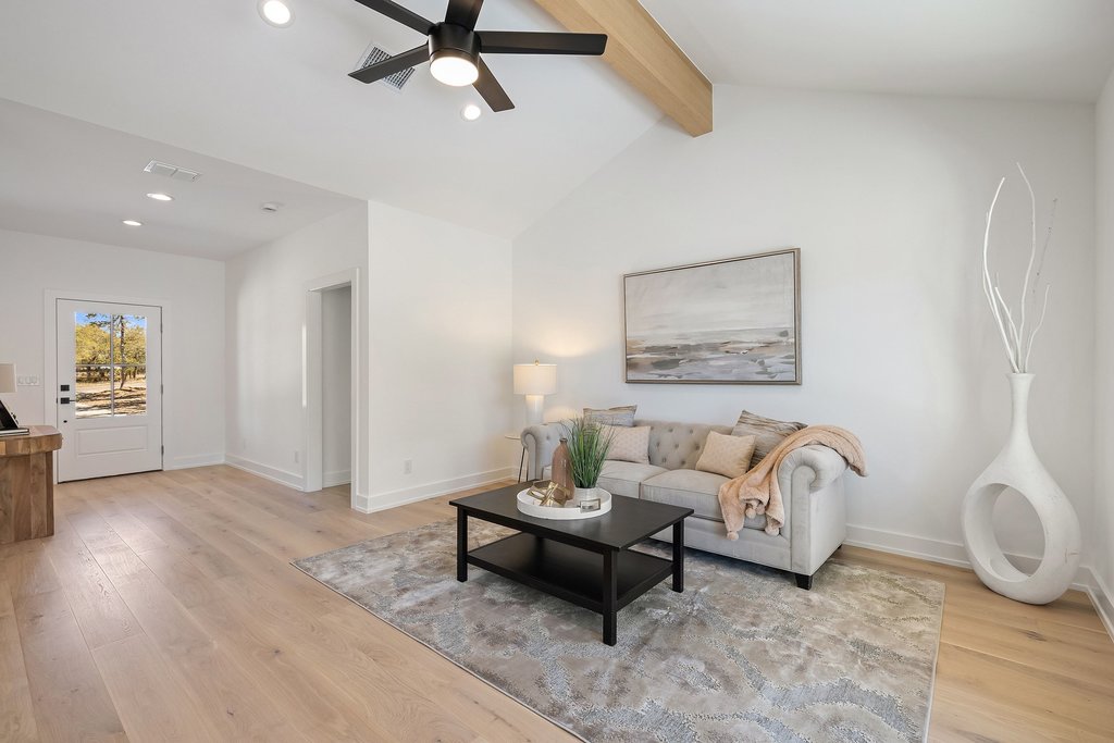 408 Rust Ranch Road Blanco, TX 78606 - Photo 9 of 35 Living room featuring light wood-style floors, ceiling fan, vaulted ceiling with beams, and recessed lighting