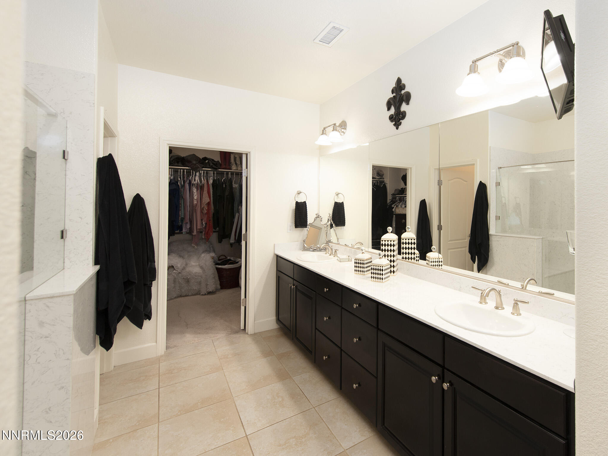 9766 Pachuca Drive Reno, NV 89521 - Photo 27 of 59 a bathroom with a double vanity sink and a mirror