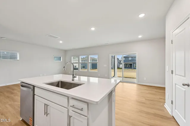 a kitchen with sink and refrigerator